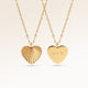 Heart-shaped gold necklace with ribbed sunburst pattern on front and personalized engraving of initials 'A + P' on back, from Mon Chou.