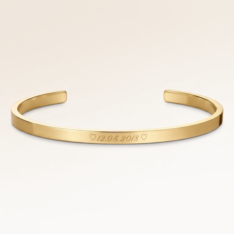 Bangle armbånd i guld med indgraveret dato og hjerter på ydersiden – personlig indgravering