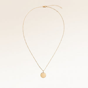 Full round gold necklace with white zirconia laid out flat with a fine adjustable gold chain and round pendant for personalised engraving