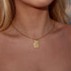 Personalized square gold necklace with rippled wave surface and space for engraving of text, coordinates or handwriting on the back