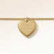 Close-up of minimalist heart-shaped heart pendant in gold with smooth surface and space for personalized engraving on the front and back