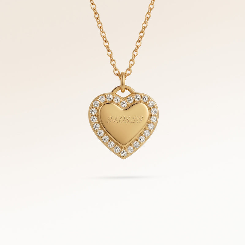 Personalized heart-shaped gold necklace with white zircons along the edge and space for engraving of 8 characters on one line on the front