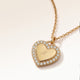 Personalized heart-shaped gold necklace with white zircons along the edge and space for engraving of 8 characters on one line on the front