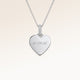 Close-up of minimalist heart-shaped heart pendant in silver with white zircons and space for personalized engraving on the front and back
