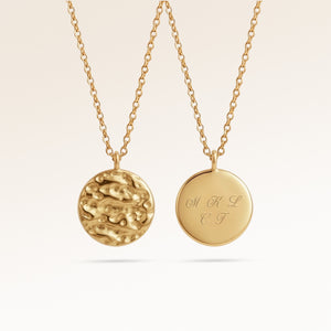 Personalized round gold necklace with softly melted finish and space for engraving of text, coordinates or handwriting on the back