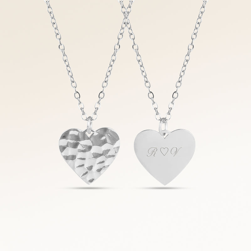 Personalized heart-shaped silver necklace with rippled wave surface and space for engraving of text, coordinates or handwriting on the back