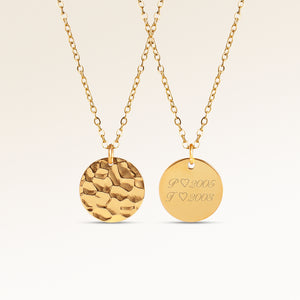 Personalized round gold necklace with rippled wave surface and space for engraving of text, coordinates or handwriting on the back