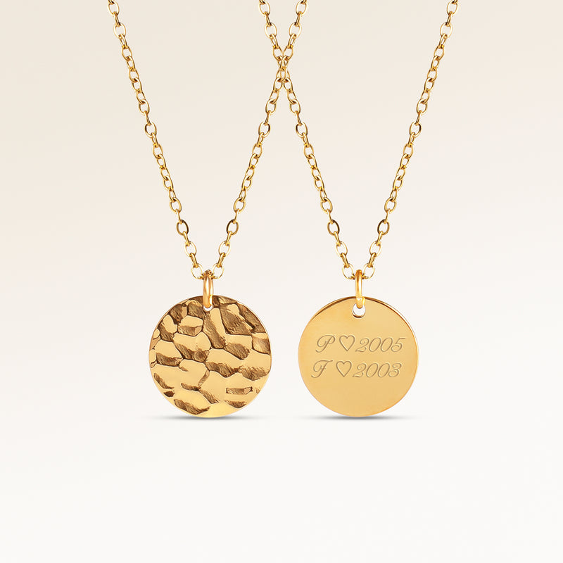 Personalized round gold necklace with rippled wave surface and space for engraving of text, coordinates or handwriting on the back