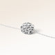 Close-up of minimalist round pendant in silver with rippled wave surface and space for engraving on back