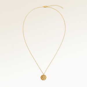 Personalized round gold necklace with rippled wave surface and space for engraving of text, coordinates or handwriting on the back