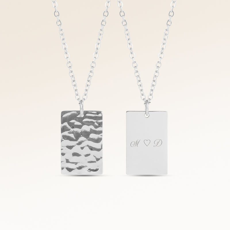 Personalized square silver necklace with rippled wave surface and space for engraving of text, coordinates or handwriting on the back