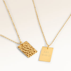 Personalized square gold necklace with rippled wave surface and space for engraving of text, coordinates or handwriting on the back
