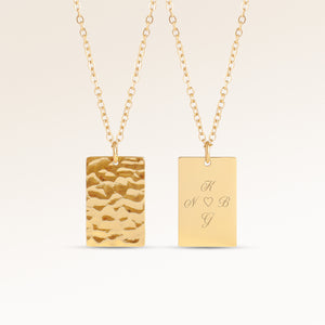 Personalized square gold necklace with rippled wave surface and space for engraving of text, coordinates or handwriting on the back