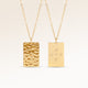 Personalized square gold necklace with rippled wave surface and space for engraving of text, coordinates or handwriting on the back