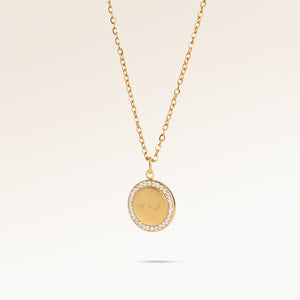 Personalized round gold necklace with white zircons along the edge and space for engraving of 8 characters on one line on the front