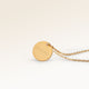 Personalized round gold necklace with space for engraving of text, coordinates or handwriting on the front and back