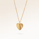Minimalist heart-shaped gold necklace with sunburst pattern and space for engraving of text, coordinates or handwriting on back.