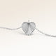 Personalized heart-shaped silver necklace with ribbed sunburst pattern and space for engraving of text, coordinates or handwriting on the back
