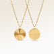 Personalized round gold necklace with ribbed sunburst pattern and space for engraving of text, coordinates or handwriting on the back