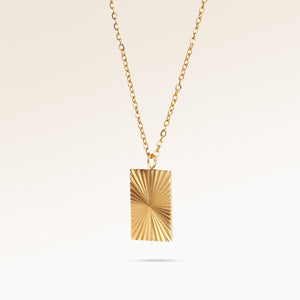 Square gold necklace with ribbed sunburst pattern side view, space for engraving on back