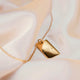 Personalized square gold necklace with space for engraving of text, coordinates or handwriting on the front and back